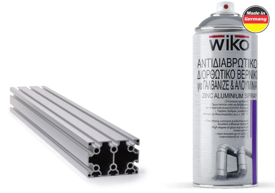 Two aluminum profile sections shown next to a can of Wiko zinc aluminum spray, on a plain white background with a small 'Made in Germany' badge.